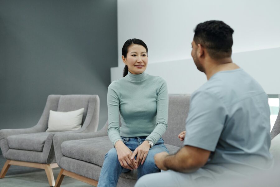 two people talking healthcare professional scrubs sofa