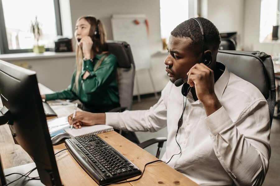 two people headset computer call centre