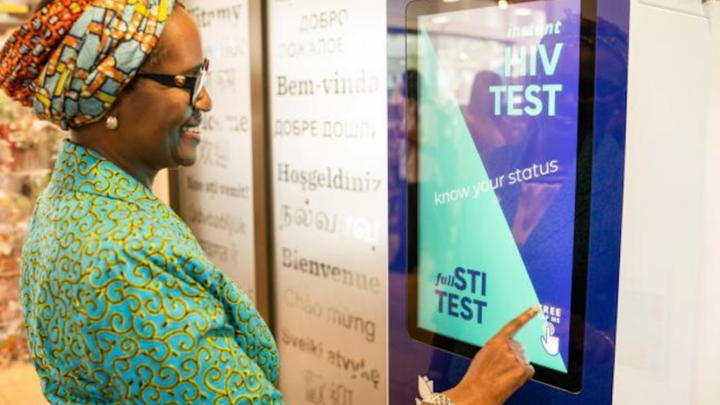 person touch vending machine hiv test