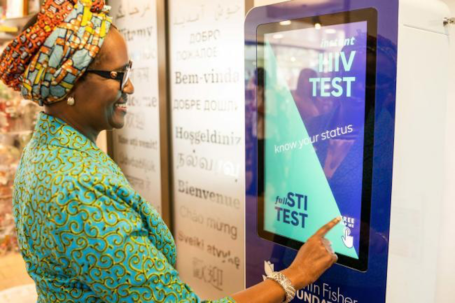 person touch vending machine hiv test