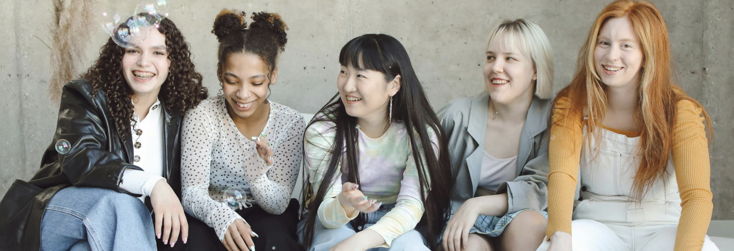 five people smiling sitting young