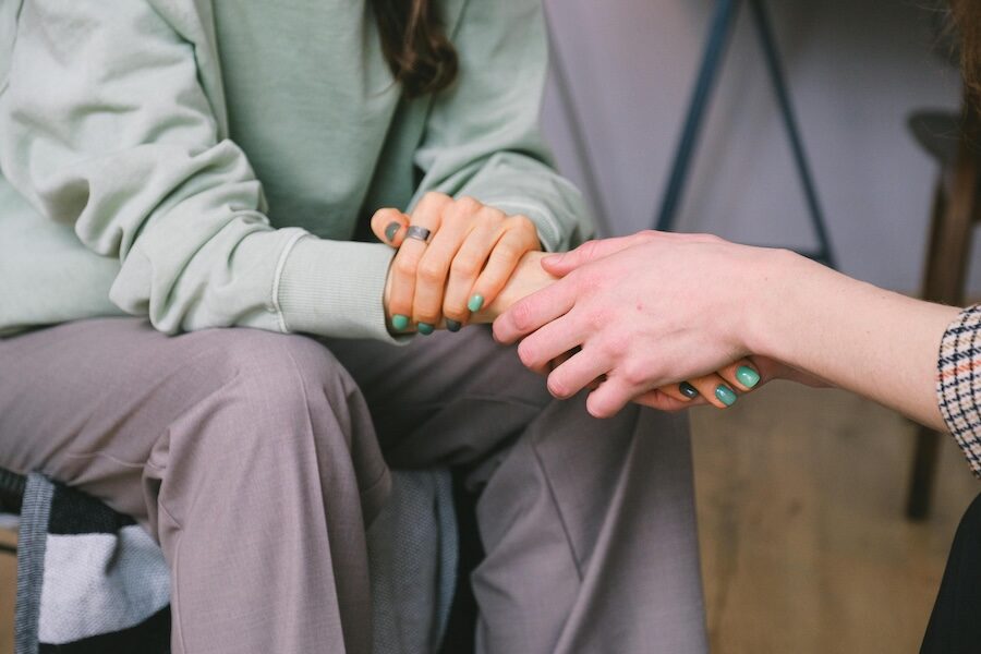 person holding hands green nail polish