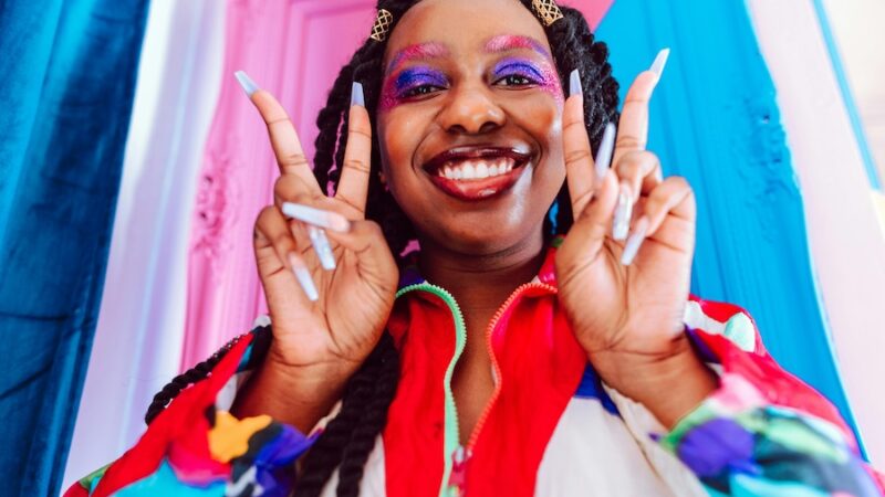 smiling person with colour make up and jacket