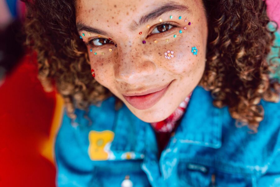 smiling person with glitter make-up