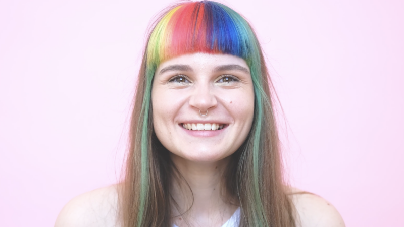 rainbow hair smiling person with nose ring