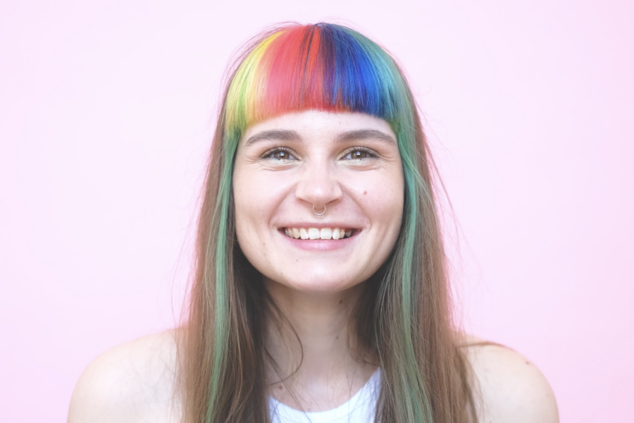 rainbow hair smiling person with nose ring