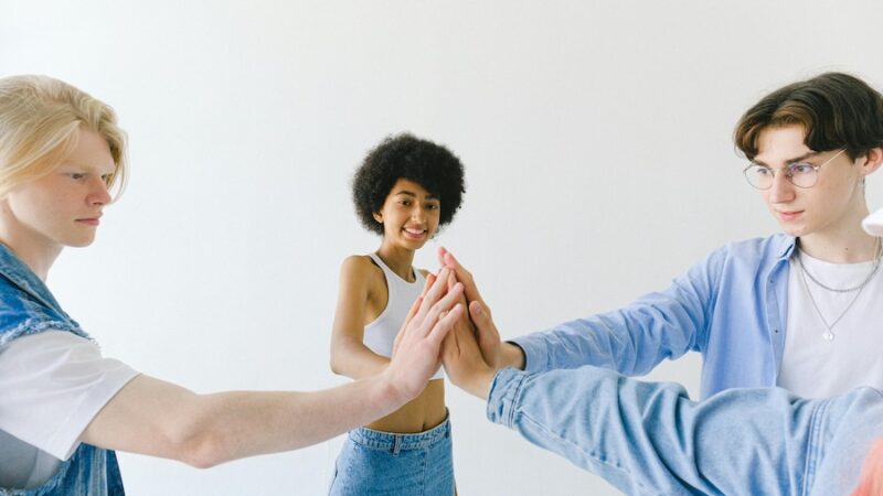 Three young people high five