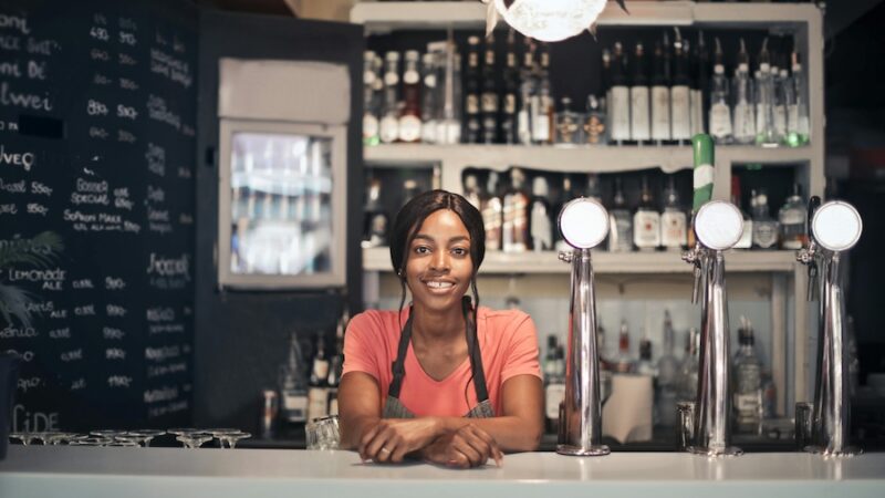 Bar tender smiling at bar