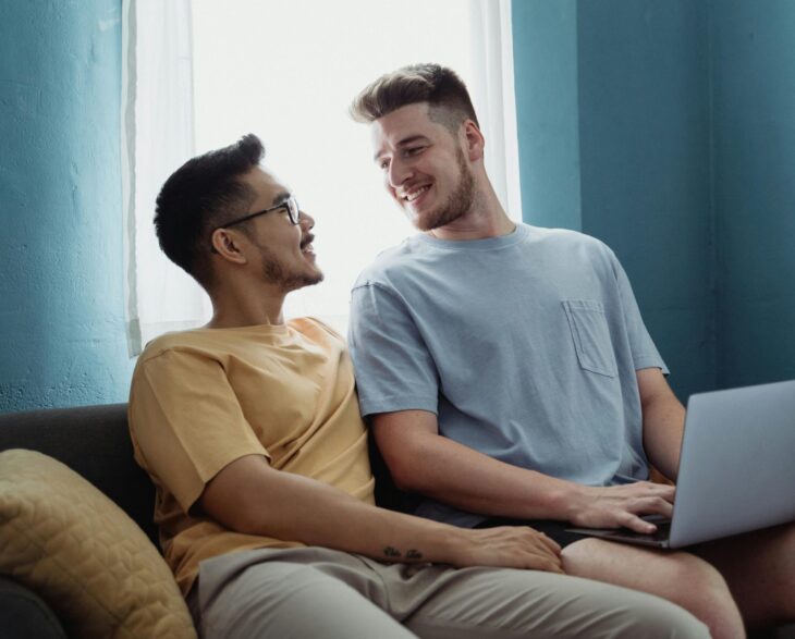 two men smiling laptop