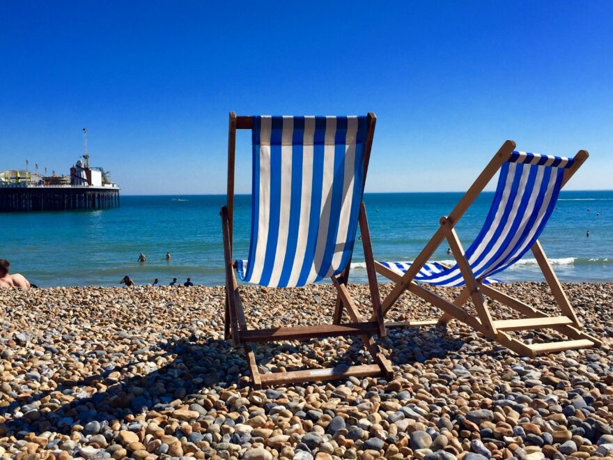rown-wooden-chair-on-beach-during-daytime