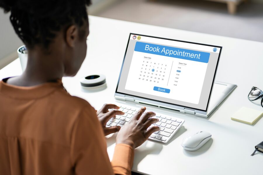 Woman booking appointment on laptop