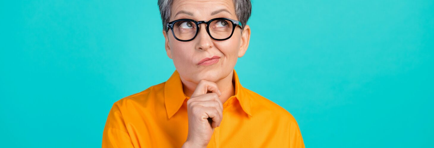 woman thinking orange top