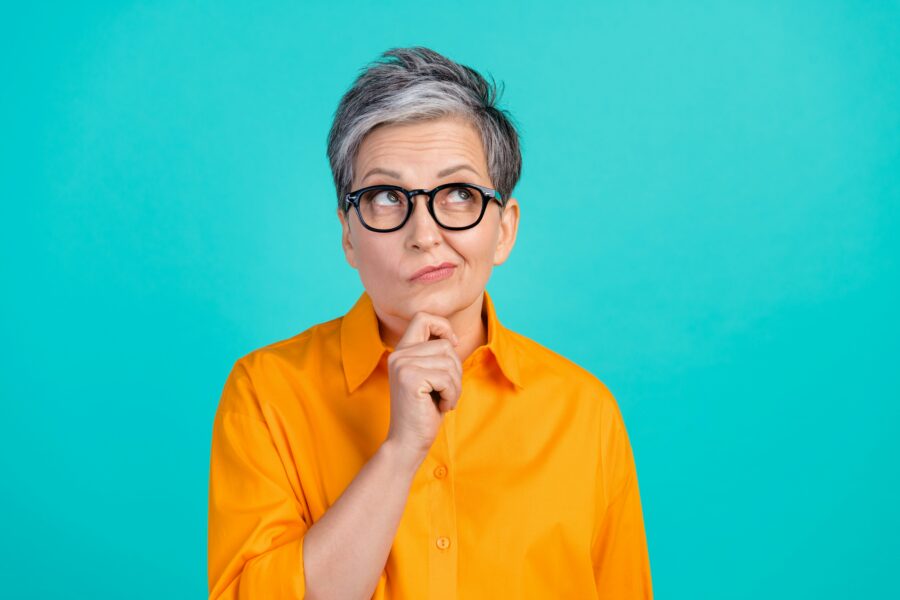 woman thinking orange top