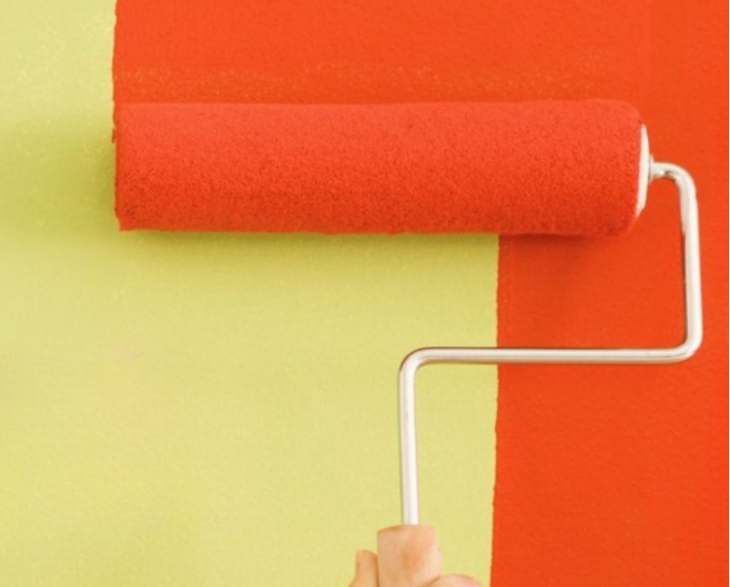 Someone painting a wall with a roller